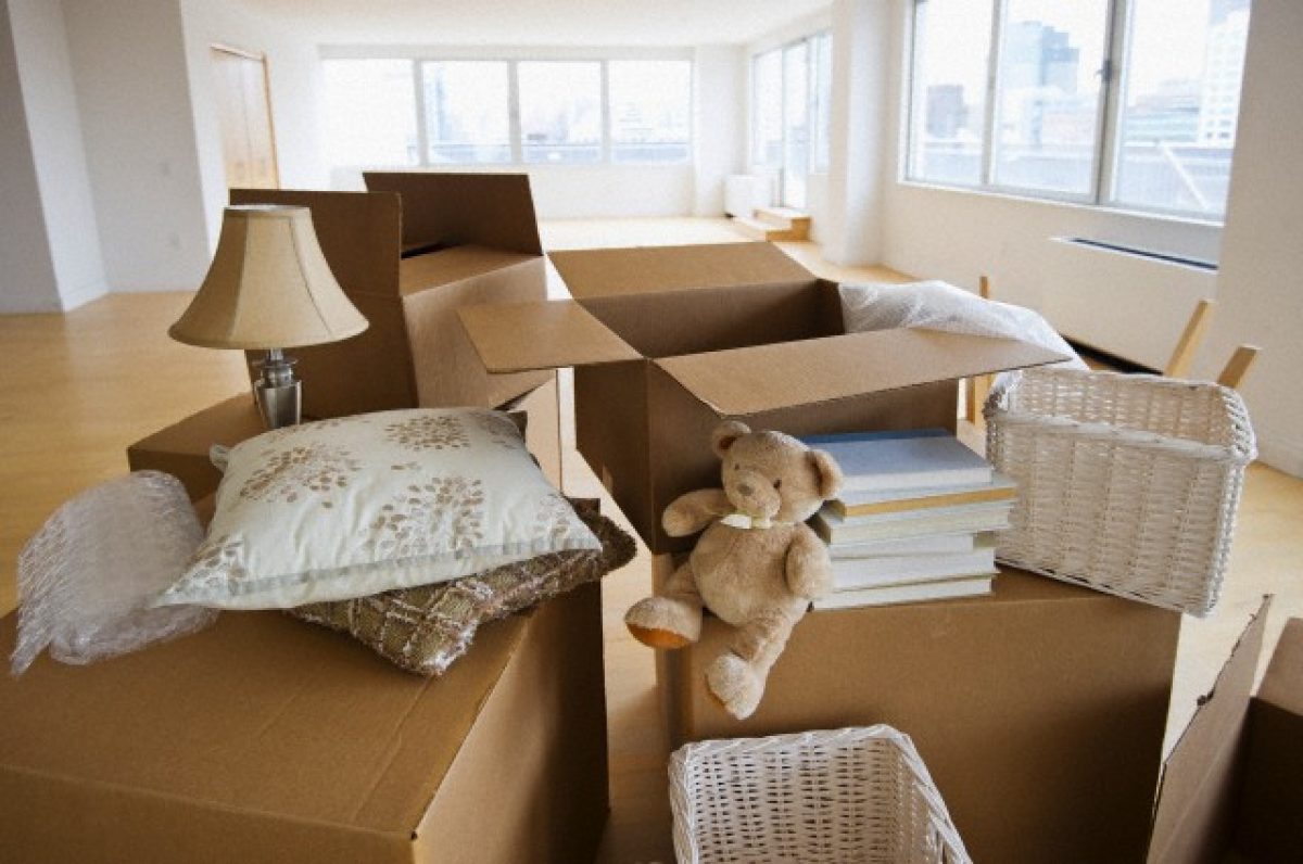 Boxes and decors stacked in room --- Image by © Tetra